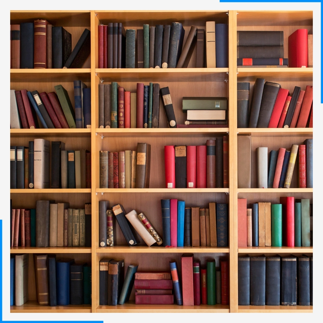 A large, three-section wooden bookshelf filled with many colorful, hardcover books.