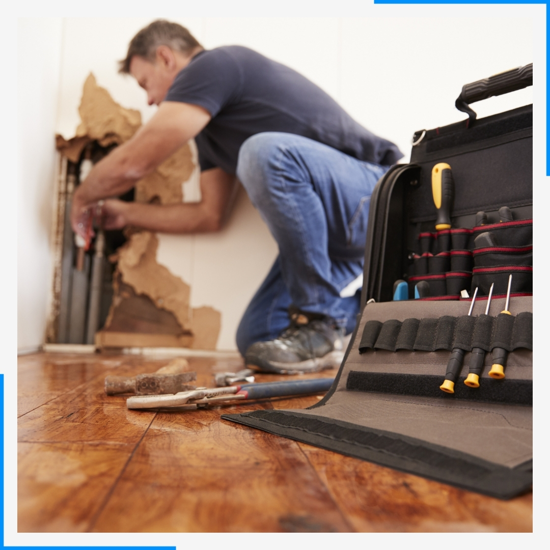 man fixing water leak